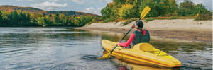 woman kayaking in the fall