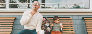 Father, son, and puppy enjoying an ice cream treat