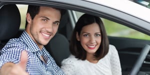 happy couple in a new car