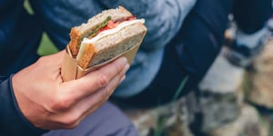 eating a sandwich while camping