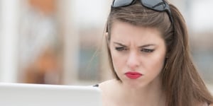 concerned person looking at laptop