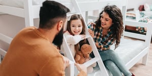 family at home with child in bedroom