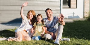 family in front of home