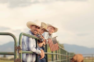 Midwest father on ranch with his two sons at sunset enjoying the sunrise