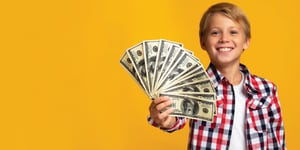 happy kid holding cash