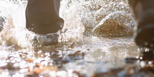 person walking into a river