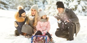 family playing in snow