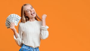 woman-happy-with-money-orange-background